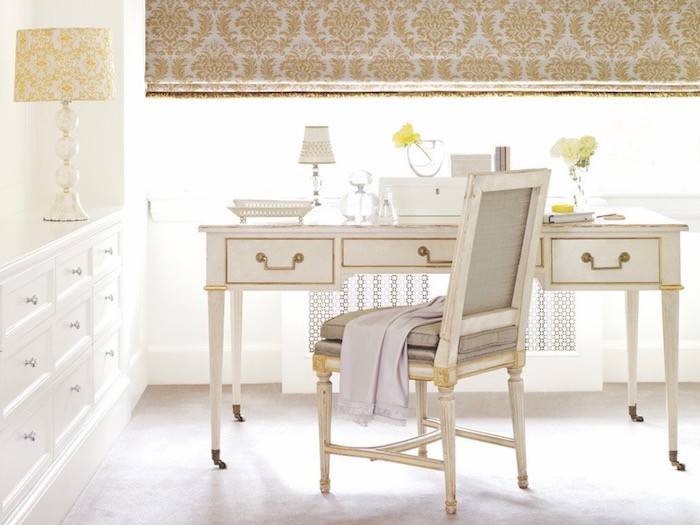 A home office with antique desk and chair.